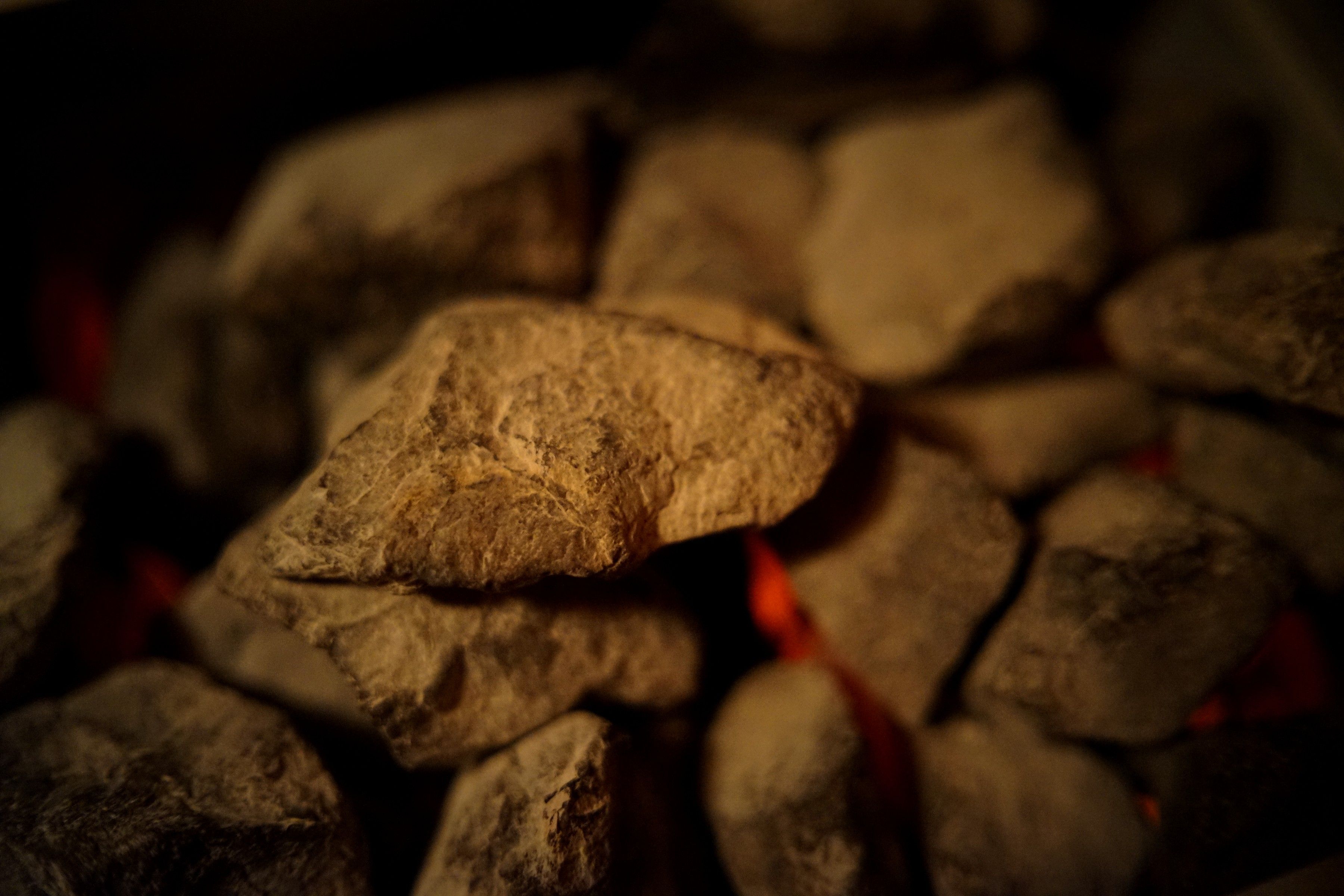 Sauna stones glowing with heat in the dark