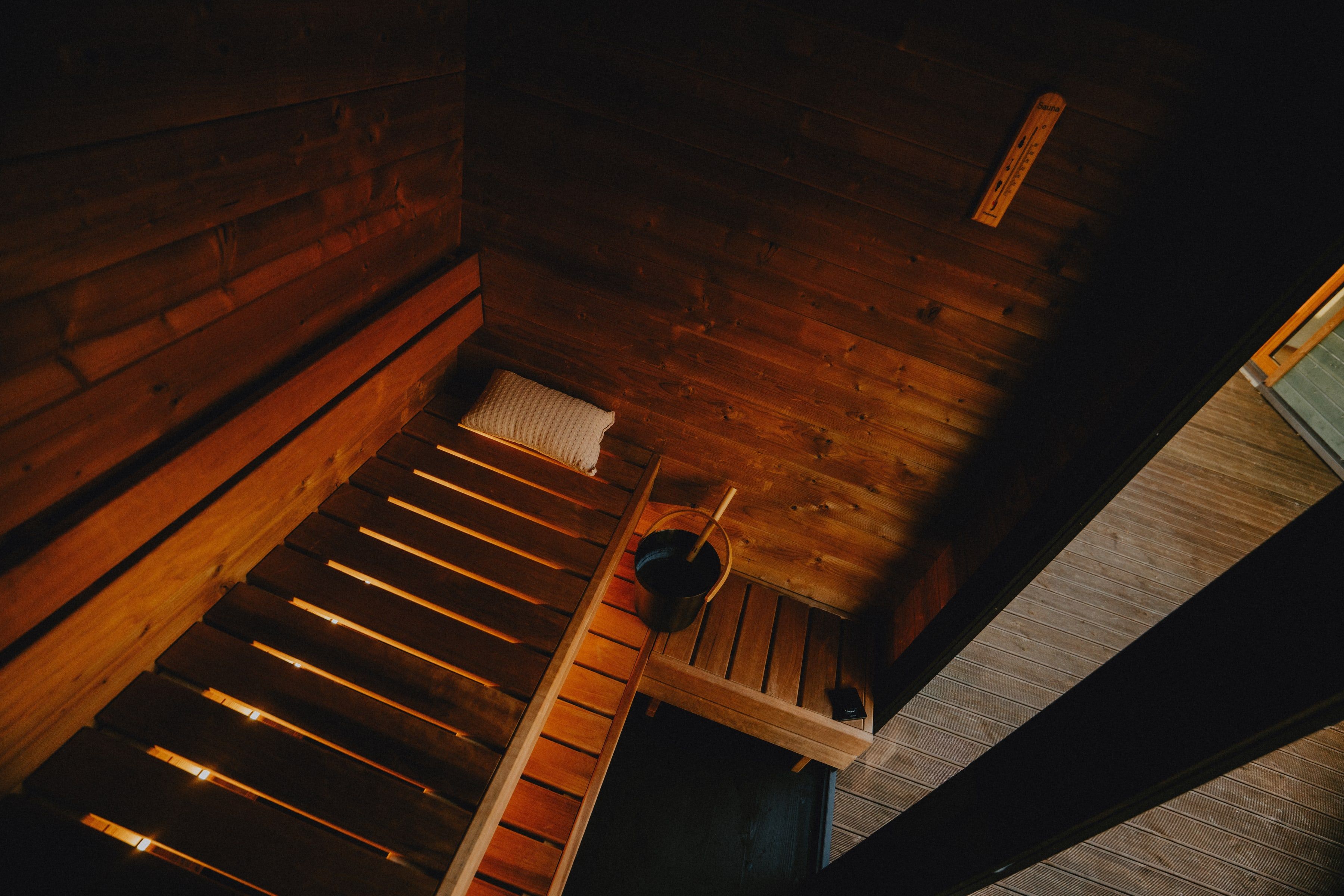 Moodem sauna from above — bench, bucket and warm light