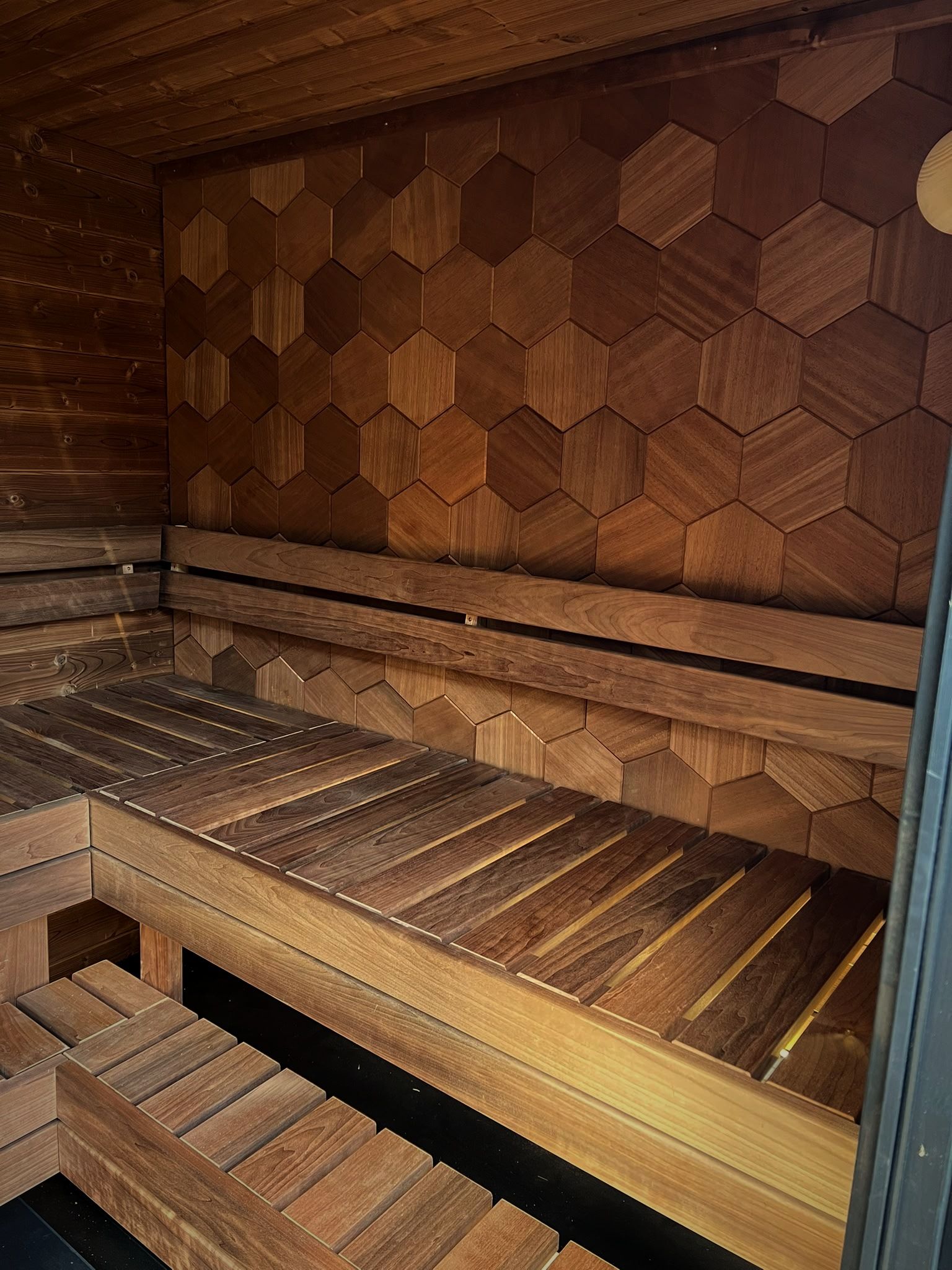 Moodem interior with the hexagon wall and two-tier benches