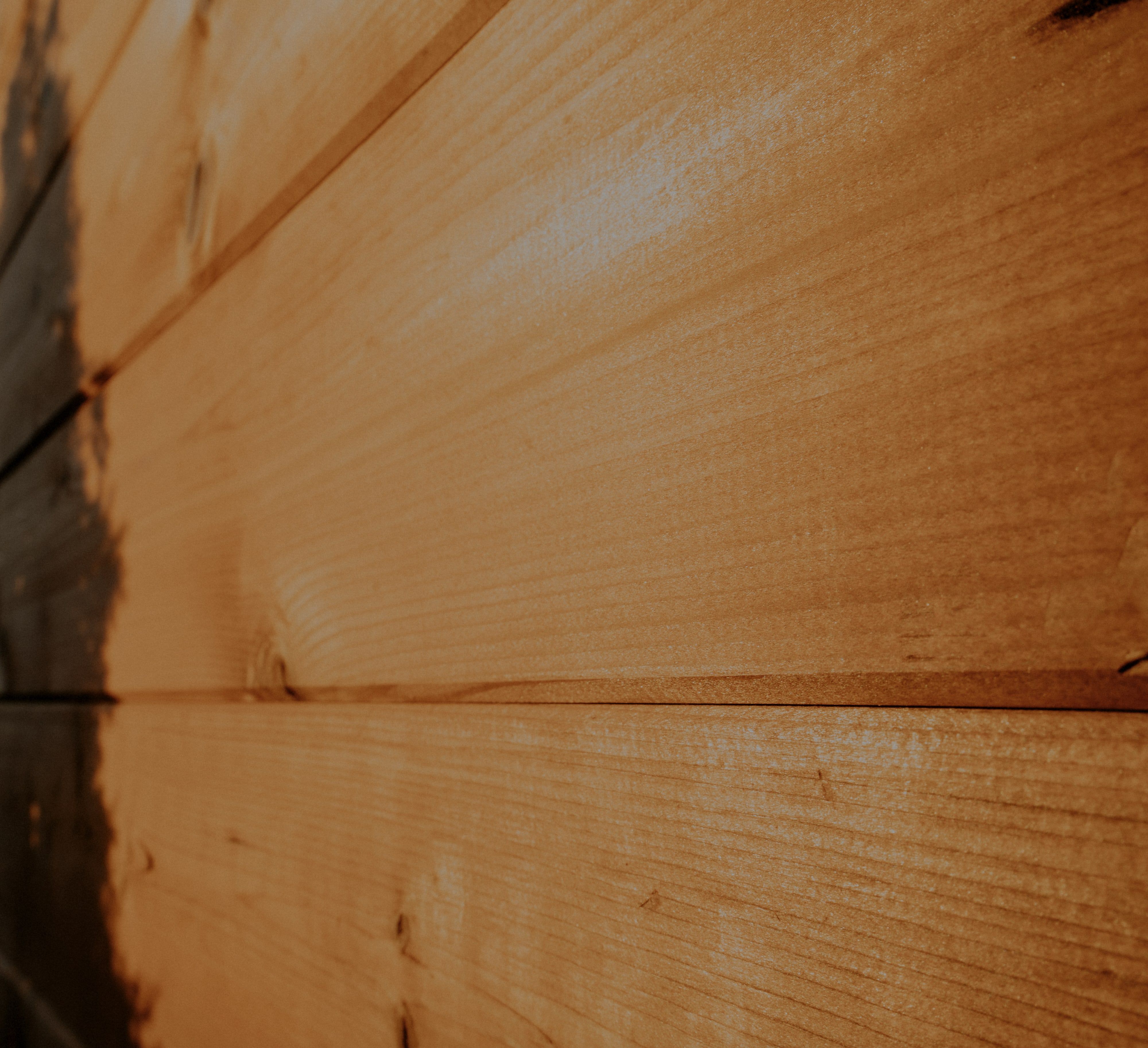 Close-up of thermally modified spruce — the grain and warmth of real thermowood