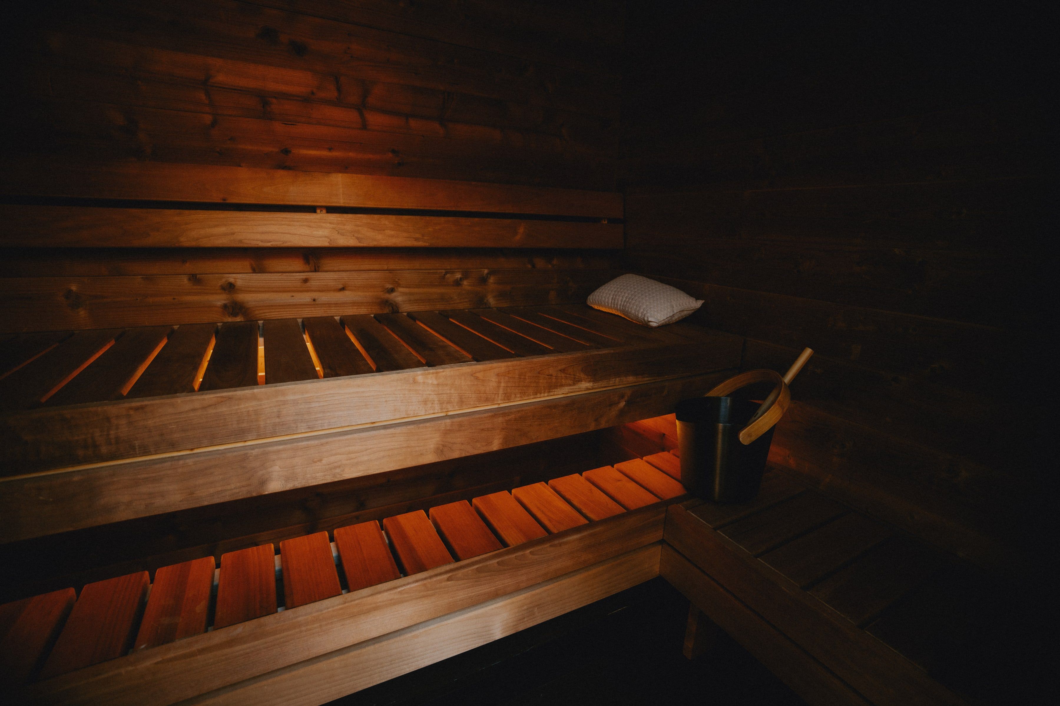 Moodem sauna interior — warm benches with pillow and bucket